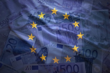 colorful waving european union flag on a euro money backgroundの写真素材