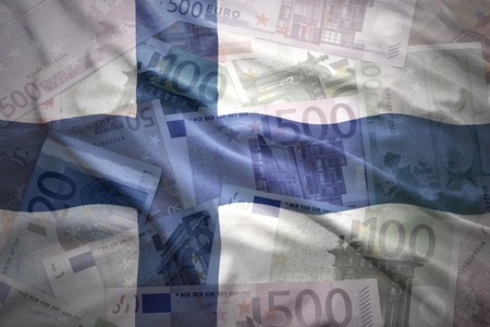 colorful waving finnish flag on a euro money backgroundの写真素材