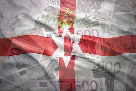 colorful waving northern ireland flag on a euro money backgroundの写真素材