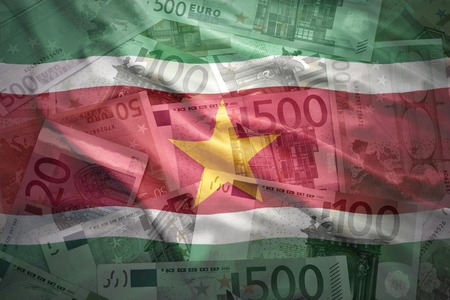 colorful waving surinamese flag on a euro money backgroundの写真素材