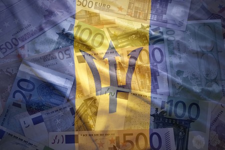 colorful waving barbados flag on a euro money background