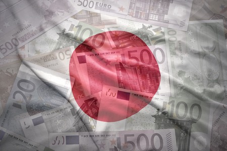 colorful waving  japanese flag on a euro money backgroundの写真素材
