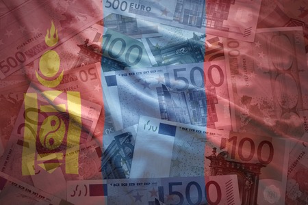 colorful waving mongolian flag on a euro money backgroundの写真素材
