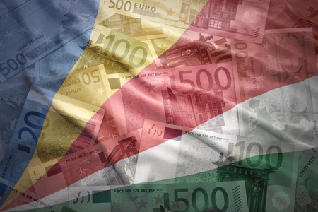 colorful waving seychelles flag on a euro money backgroundの写真素材