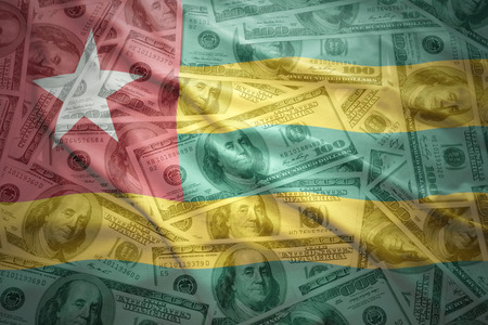 colorful waving  flag on a american dollar money backgroundの写真素材