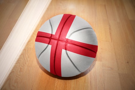 basketball ball with the national flag of england lying on the floor near the white lineの写真素材
