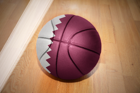 basketball ball with the national flag of qatar lying on the floor near the white lineの写真素材