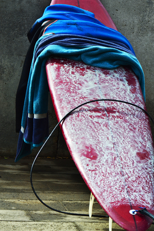 red surfboard is on the floorの写真素材