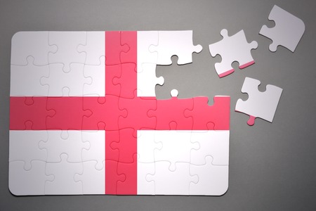 broken puzzle with the national flag of england on a gray backgroundの写真素材