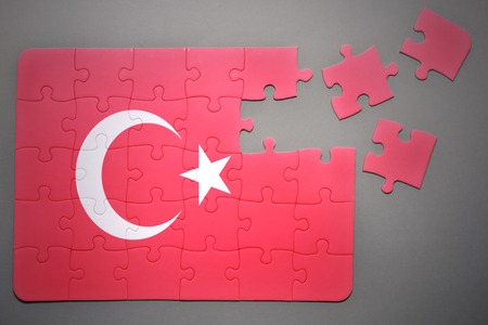 broken puzzle with the national flag of turkey on a gray backgroundの写真素材