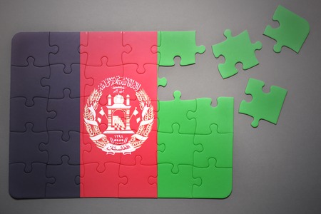 broken puzzle with the national flag of afghanistan on a gray backgroundの写真素材
