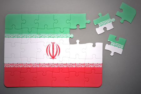 broken puzzle with the national flag of iran on a gray backgroundの写真素材