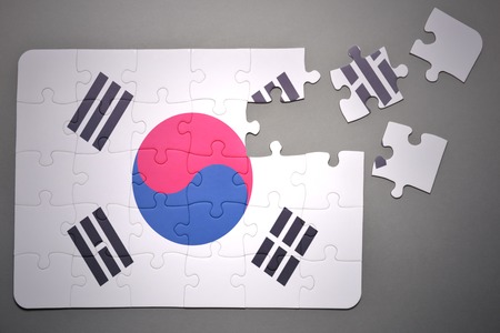broken puzzle with the national flag of south korea on a gray backgroundの写真素材