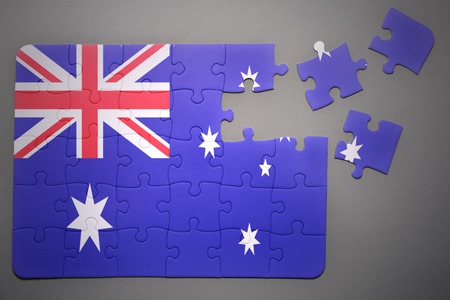 broken puzzle with the national flag of australia on a gray backgroundの写真素材