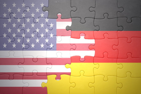 puzzle with the national flag of united states of america and germany .conceptの写真素材