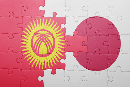 puzzle with the national flag of kyrgyzstan and japan. conceptの写真素材