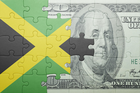 puzzle with the national flag of jamaica and dollar banknote . conceptの写真素材