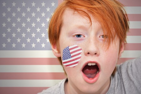 redhead fan boy with american flag painted on his face. on the american  flag backgroundの写真素材