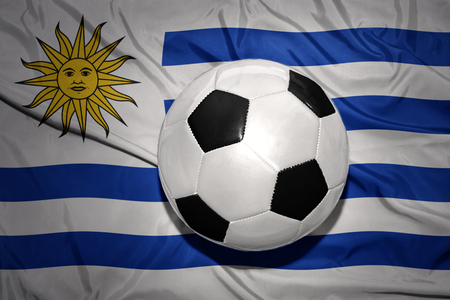 vintage black and white football ball on the national flag of uruguayの写真素材