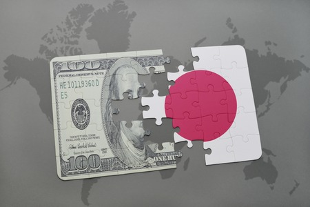 puzzle with the national flag of japan and dollar banknote on a world map background. 3D illustrationの写真素材