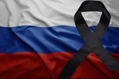 waving national flag of russia with black mourning ribbonの写真素材