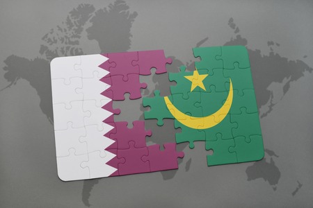 puzzle with the national flag of qatar and mauritania on a world map background. 3D illustrationの写真素材