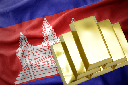 gold reserves. shining golden bullions on the cambodia flag backgroundの写真素材