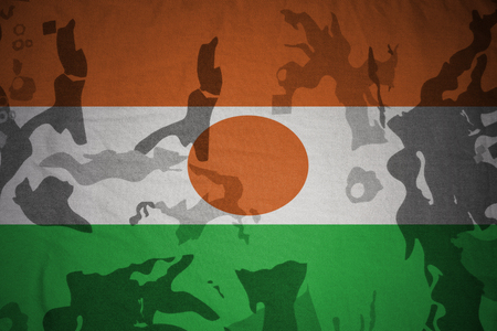 flag of niger on the khaki texture background. military conceptの写真素材