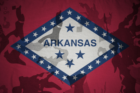 arkansas state flag on the khaki texture background. military conceptの写真素材