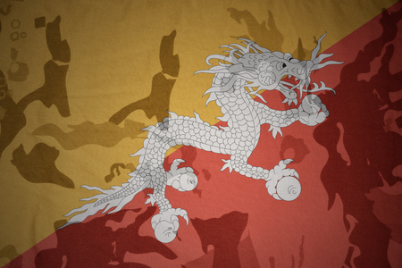 flag of bhutan on the khaki texture background. military conceptの写真素材