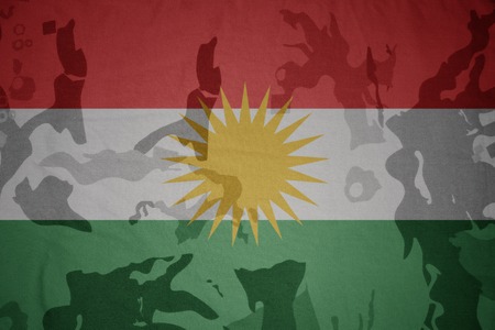 flag of kurdistan on the khaki texture background. military conceptの写真素材