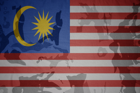 flag of malaysia on the khaki texture background. military conceptの写真素材