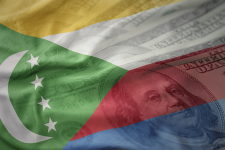 colorful waving national flag of comoros on a american dollar money background. finance conceptの写真素材