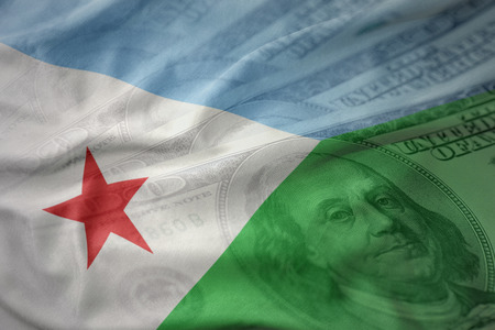 colorful waving national flag of djibouti on a american dollar money background. finance conceptの写真素材