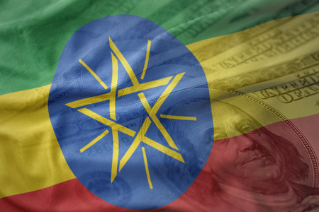 colorful waving national flag of ethiopia on a american dollar money background. finance conceptの写真素材