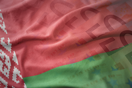 colorful waving national flag of belarus on a euro money banknotes background. finance conceptの写真素材