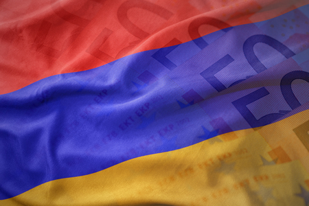 colorful waving national flag of armenia on a euro money banknotes background. finance conceptの写真素材