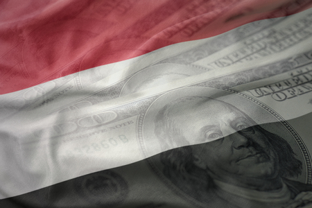 colorful waving national flag of yemen on a american dollar money background. finance conceptの写真素材