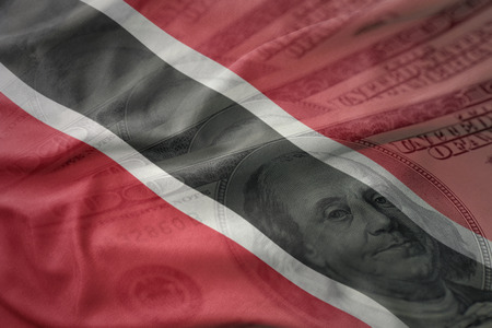 colorful waving national flag of trinidad and tobago on a american dollar money background. finance conceptの写真素材