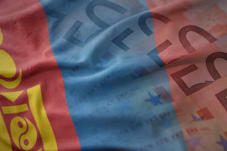 colorful waving national flag of mongolia on a euro money banknotes background. finance conceptの写真素材