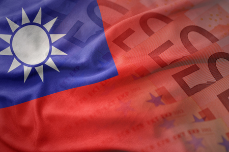 colorful waving national flag of taiwan on a euro money banknotes background. finance conceptの写真素材