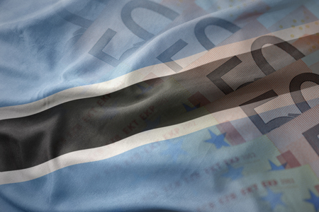 colorful waving national flag of botswana on a euro money banknotes background. finance conceptの写真素材