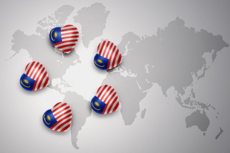 five hearts with national flag of malaysia on a world map background..concept.3D illustrationの写真素材