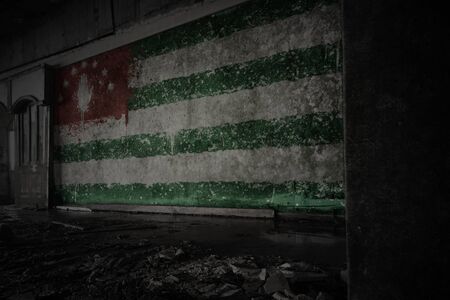 painted flag of abkhazia on the dirty old wall in an abandoned ruined house. conceptの写真素材