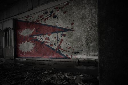 painted flag of nepal on the dirty old wall in an abandoned ruined house. conceptの写真素材