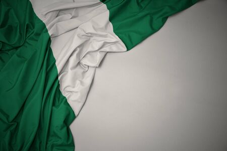 waving colorful national flag of nigeria on a gray background.の写真素材