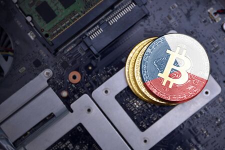 golden shining bitcoins with flag of czech republic on a computer electronic circuit board. bitcoin mining concept.の写真素材