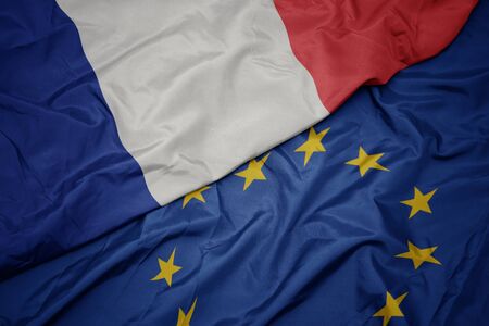 waving colorful flag of european union and national flag of france . macroの写真素材