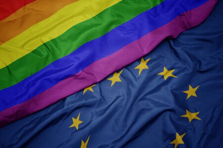 waving colorful flag of european union and gay rainbow flag .macroの写真素材