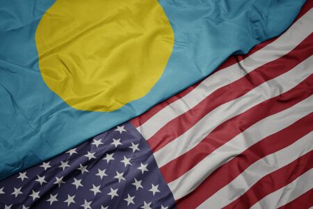 waving colorful flag of united states of america and national flag of Palau. macroの写真素材